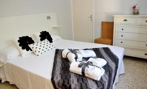 una camera da letto con un letto con asciugamani e un comò di CAL MILLÀ a Os de Balaguer
