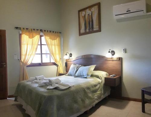 Säng eller sängar i ett rum på Posada del Infinito