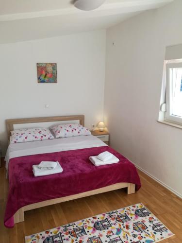 a bedroom with a bed with a purple blanket at Apartment Ana Marija Savar in Savar