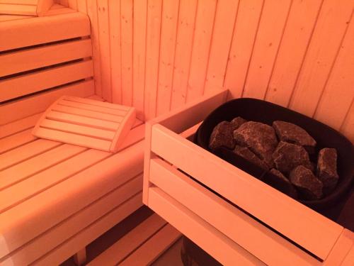 a sauna with a box of rocks in it at Apartmány Sportrelax in Albrechtice v Jizerských horách