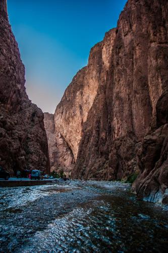 a river in the middle of a canyon at Les Jardins De Todgha gorges de todra tinghir in Aït Baha