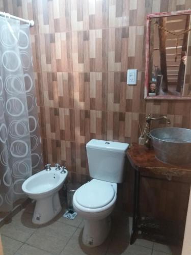 a bathroom with a toilet and a sink at CABAÑA EN TANTI in Tanti