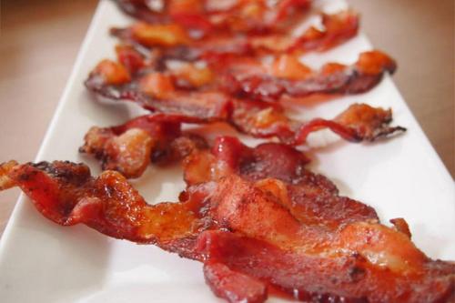 a white plate of food with bacon on it at Auberge Les Bons Matins in Montréal