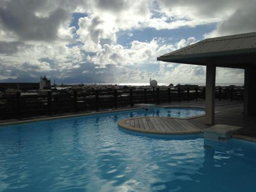 a swimming pool on the roof of a building at Régent 3e étage Papeete in Papeete