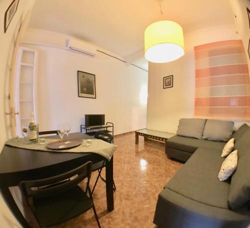 a living room with a couch and a table at Plaza España Central Apartment in Barcelona