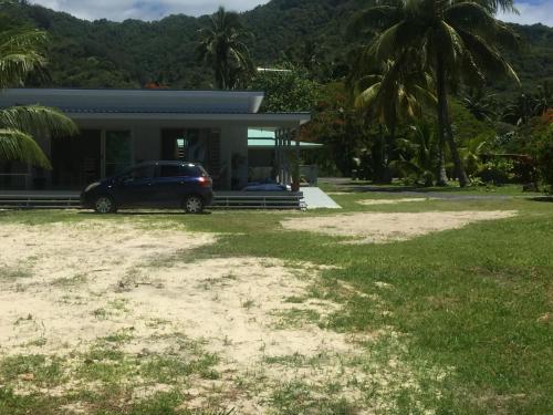 a house with a car parked in front of it at Ariki Dream Villa in Titikaweka