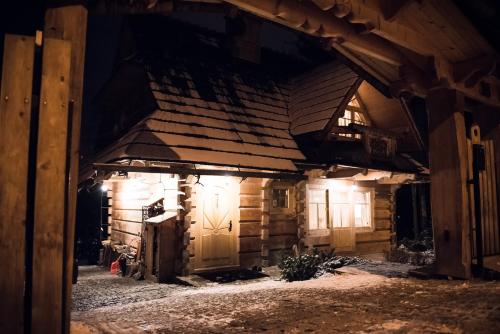 an old wooden building with a door in the dark at Zakopane Best in Zakopane