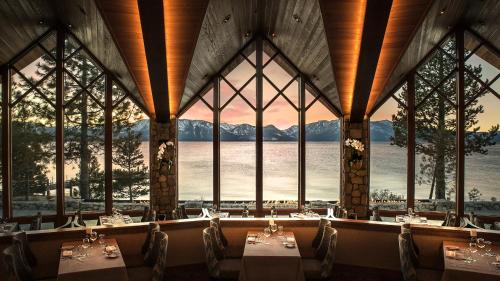 a dining room with a large window overlooking the ocean at Edgewood Tahoe Resort in Stateline