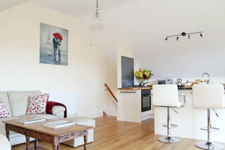 a living room with a couch and a table at Dove Lodge in Painswick