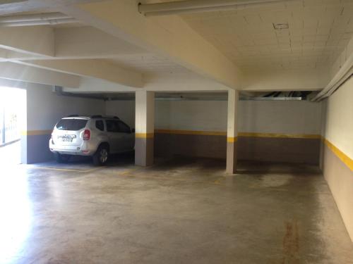 a car parked in an empty parking garage at Apartamento no Centro de Gramado in Gramado