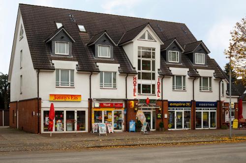 a large white building on the side of a street at Hotel Ideal in Lübeck