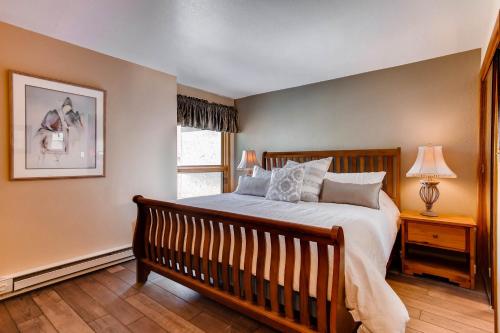a bedroom with a large bed and a window at The Plaza Condominiums by Crested Butte Mountain Resort in Mount Crested Butte