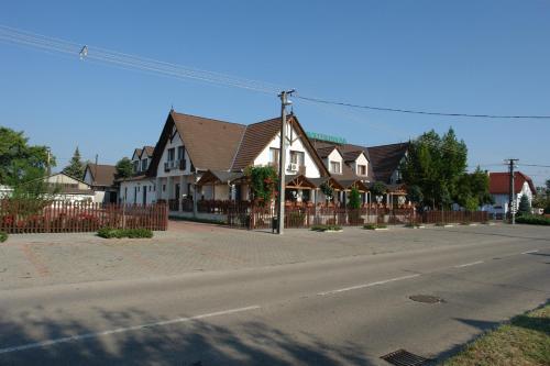 a row of houses on a street at Koller Panzió in Bonyhád