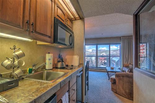 a kitchen with a sink and a large window at 4429 Beaver Run Resort in Breckenridge