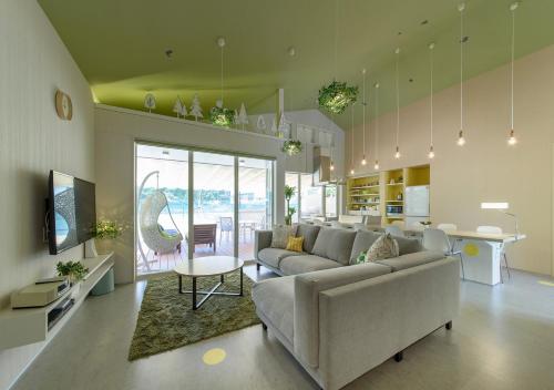 a living room with a couch and a table at Holiday House Green Garden in Gujo