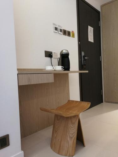 a stool in a room with a coffee machine on a counter at Wifi Boutique Hotel in Hong Kong
