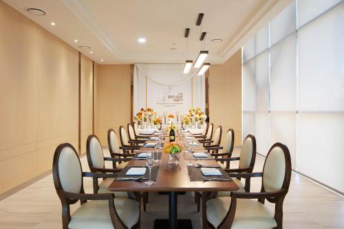 a long dining room with a long table and chairs at Days Hotel & Suites by Wyndham Incheon Airport in Incheon