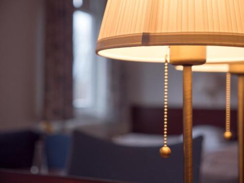 a close up of a lamp with a chain at Hotel Åberg Centralhotellet in Tranås