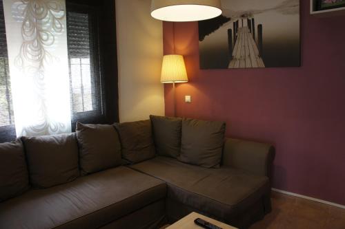 a living room with a couch and a table at villa las tres perlas in Algorfa