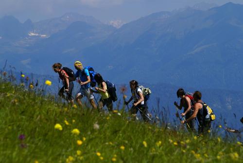a group of people walking on a grassy hill at Baita Mas Sora Sass in Rabbi