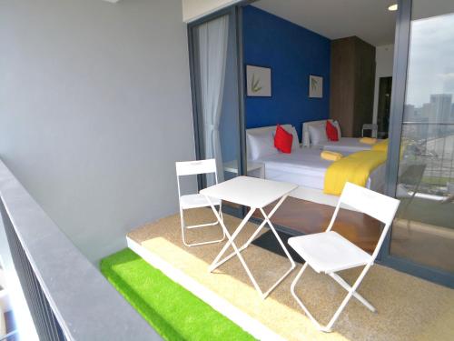 a room with two chairs and a table and a bed at The Landmark Seaview Gurney in George Town