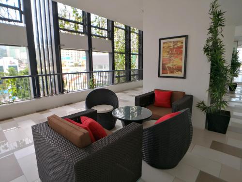 a living room with two couches and a table at The Landmark Seaview Gurney in George Town