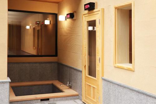 a bathroom with a sink and a mirror on the wall at Asia Pacific Hotel Beitou in Taipei