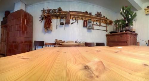 a large wooden table in a room with a table at Kačiūniškis in Kaciūniškiai