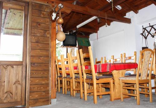 a dining room with a table and chairs and a television at Villa Nymphea Water Lily in Hisarya