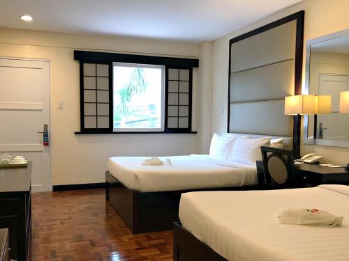 A bed or beds in a room at Jinjiang Inn - Boracay Station 1