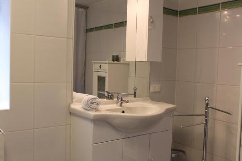 a white bathroom with a sink and a mirror at Perau in Gmünd in Gmünd in Kärnten