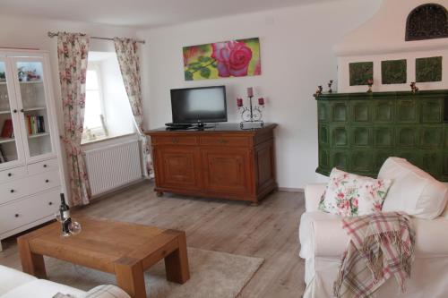 a living room with a couch and a tv on a cabinet at Perau in Gmünd in Gmünd in Kärnten