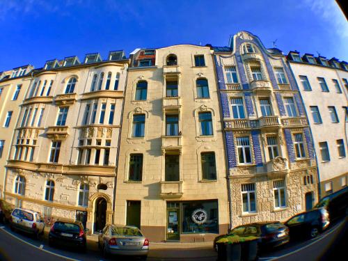 a large building with cars parked in front of it at Blue Edition Cologne in Cologne
