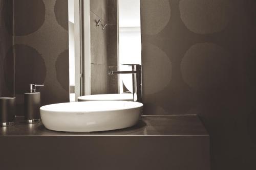 a bathroom with a white sink and a mirror at G Design Hotel in Ljubljana