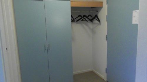 a closet with a blue cabinet in a room at Djurs-BnB - Rimsøhuset in Rimsø