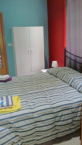 a bedroom with a large bed and a white cabinet at Bed Relax Etnaview in Zafferana Etnea