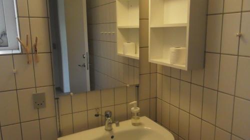 a bathroom with a sink and a mirror at Djurs-BnB - Rimsøhuset in Rimsø