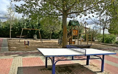 a bench in a park with a playground at Casa Rural Guadiela II in San Pedro Palmiches