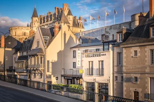 a row of buildings with a castle in the background at Hotel Bellevue in Amboise