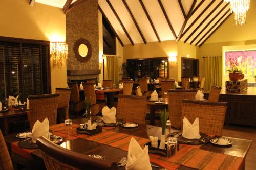 a dining room with a table and chairs in a restaurant at The Retreat at Ngorongoro in Karatu