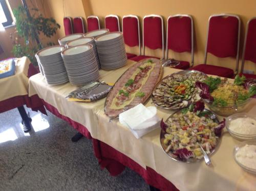 a table with plates of food on it at L Anfora in Tramatza