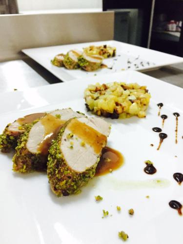 a white plate with some food on a table at L Anfora in Tramatza