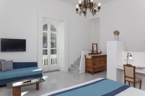 a living room with a blue couch and a table at Villa Manning Relais in Sorrento