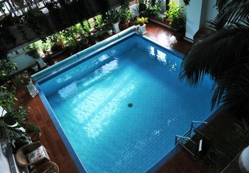 an overhead view of a large blue swimming pool at White House in Prague