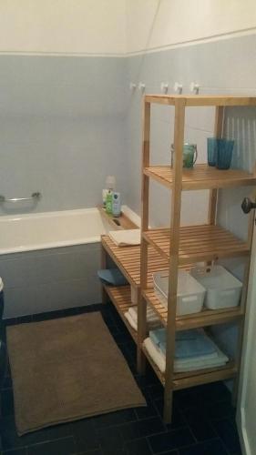 a bathroom with a sink and a shelf with toilets at Casa da Madrinha II in Monte Gordo