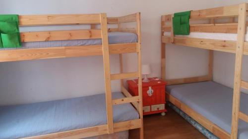 a room with three bunk beds in a room at Casa da Madrinha II in Monte Gordo