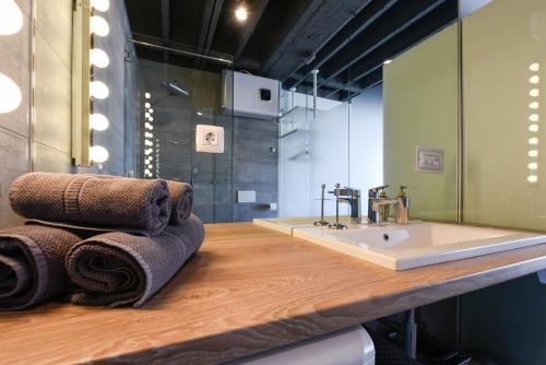 a bathroom with a sink and towels on a counter at Deluxe Apartments Santa Lucia in Zadar