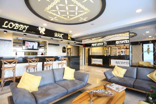 a lobby with couches and a bar in a store at Life Corner Hotel in İzmir