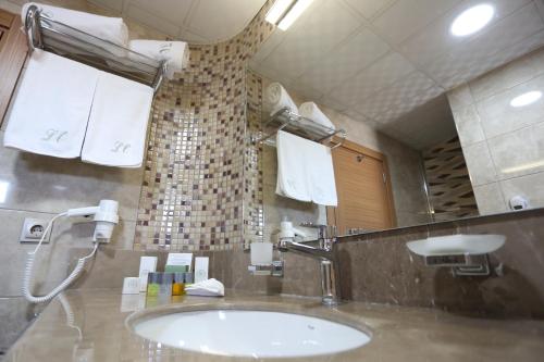 a bathroom with a sink and a mirror at Life Corner Hotel in Izmir
