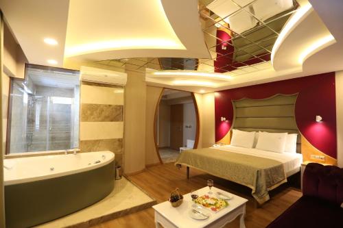 a hotel room with a bed and a bath tub at Life Corner Hotel in Izmir